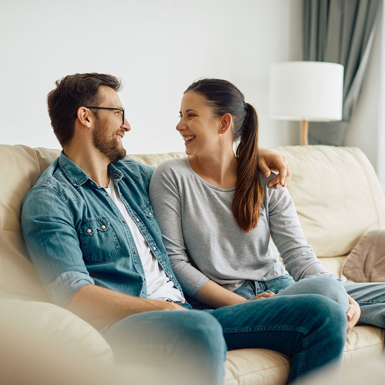 Couple looking at each other in the sofa