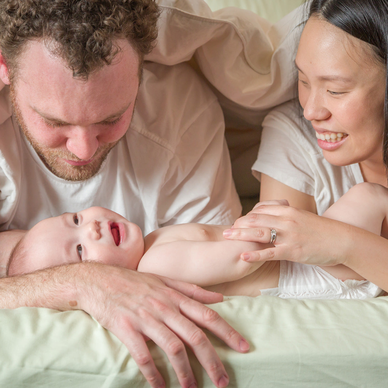 mixed race chinese and caucasian baby boy laying